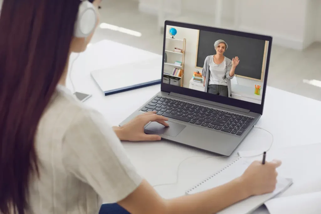 girl attending a lesson from her laptop to earn an online degree from UK